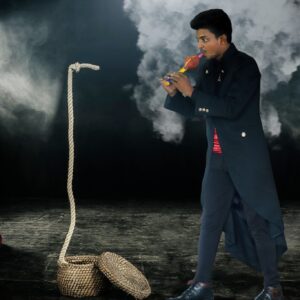 Magician doing snake charmer trick with rope